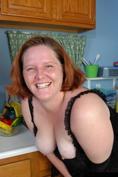 Fat redhead mature MILF Adrienne showcasing her big ass in stockings