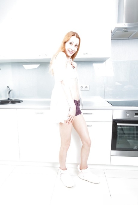 Older redhead model Kler undressing to reveal her hairy pussy