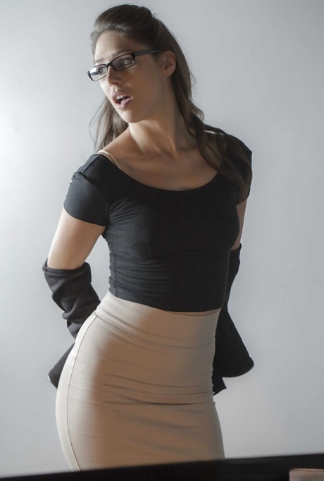 Glasses topped brunette babe Anna Morna taking upskirt self shot in office