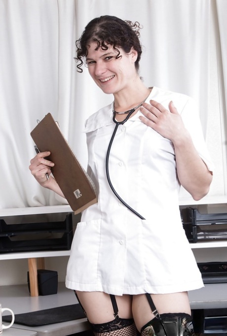 Mature brunette Sunshine shedding doctor garb before exposing hairy twat