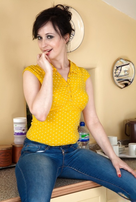 Middle aged lady Nikita pulling down jeans and panties for hairy pussy display