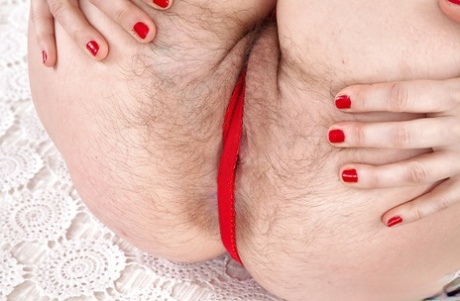 Mature solo model Nikita proudly showing off really hairy pussy