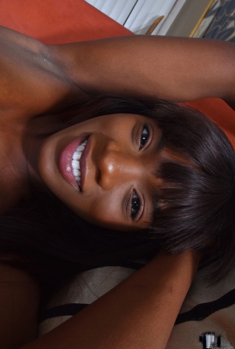 Ebony beauty pulls down her panties to finish getting naked for nude poses