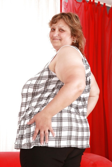 Fatty granny with huge boobs and ass stripping and spreading her legs