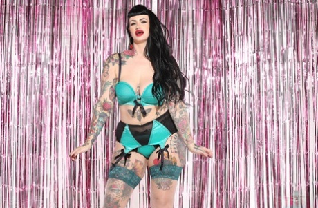 Voluptuous tattooed model Lucy Vixen shows her sexy curves in hot lingerie
