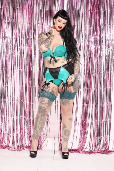 Voluptuous tattooed model Lucy Vixen shows her sexy curves in hot lingerie