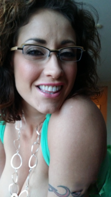 Wife in green lingerie Eva Notty reveals her big fake tits and rubs her clit