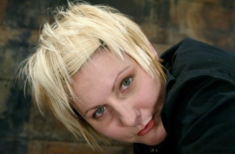 Beautiful blonde Vendetta gets her shaved cunt fingered in metal bondage