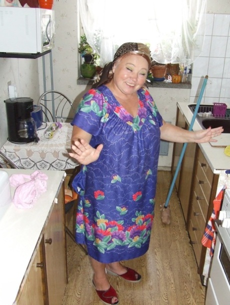 Fat granny Regina strips her clothes and poses while cleaning the kitchen