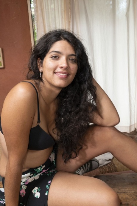 Brunette with a sexy smile Maria F opens her legs wide to show her hairy pussy