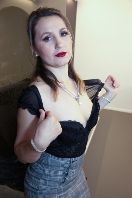Sexy MILF Olga Love exposes her juggs and round ass before touching her twat