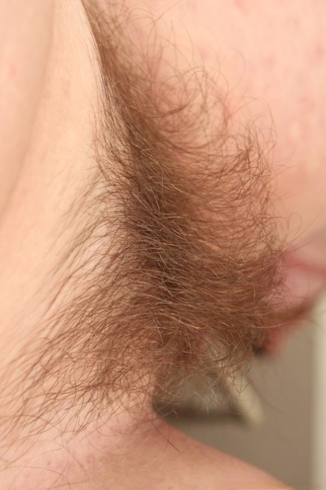 Buxom MILF with natural tits Saxana showing her hairy pussy in the kitchen