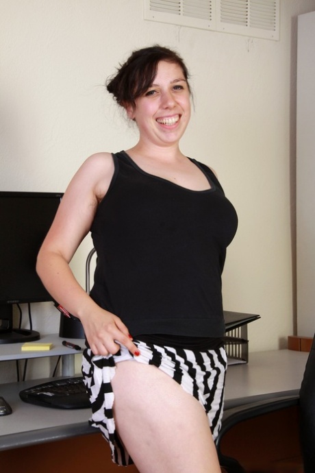 Curvaceous office worker Nadeen does enticing striptease to flaunt hairy pussy