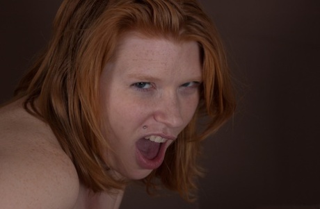 Pudgy redhead MILF Madison Young uncovers natural tits & thickly hairy bush