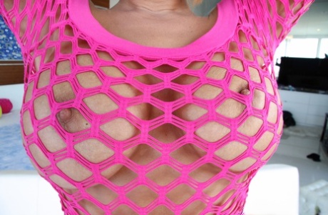 Busty MILF Melanie Monroe shows her big booty in pink fishnet dress