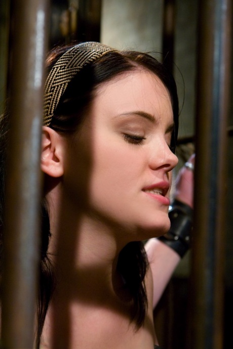 Stacked brunette Raina Verene licks her master's dick while in bondage