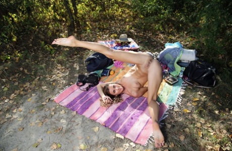 Sexy skinny babe Juck shows her small tits & her shaved pussy outdoors