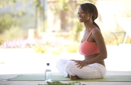 Ebony girl Jezabel Vessir uncovers her big boobs while doing yoga