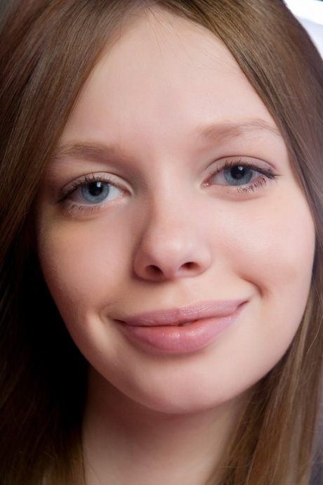 Pretty eyed teen Kylie A teases with her slim figure in pink stockings