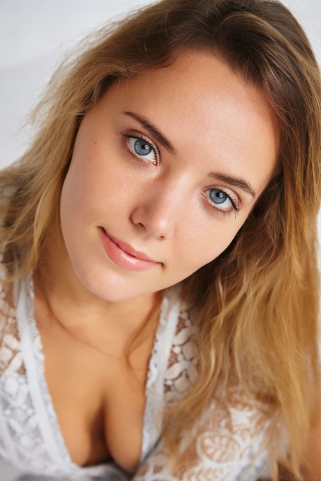 Blue eyed teen Mango A exposes her suckable boobs and poses naked