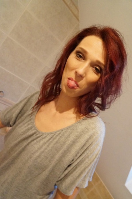 Skinny redhead Breanne Tozeva fingers her trimmed pussy in the bathroom