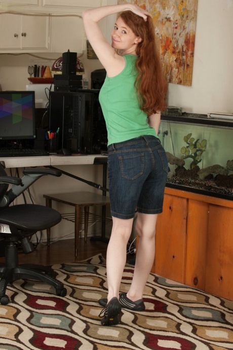 Redheaded amateur girl Abbey Rain flaunts her big boobs and hot pussy