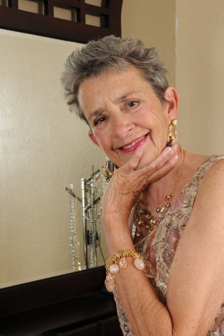Slim granny Cassie doffs her dress and flaunts her bushy vagina