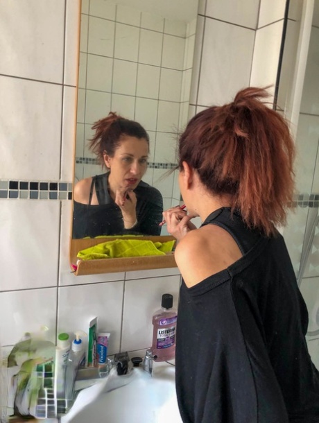 Redheaded amateur woman Betty Spaghetti shows her small tits & holes