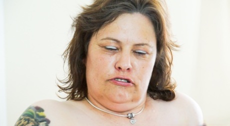 Fat granny Tiger shows her big butt and tits before masturbating in stockings