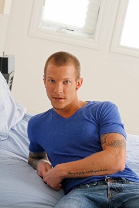 Tattooed gay hunk Jaxon Colt strips fully naked and shows off his big dick