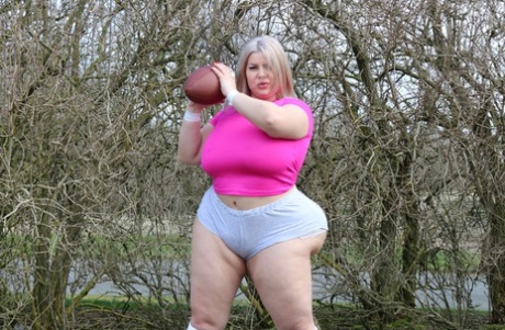 Curvaceous football player Natasha Crown flaunts her huge ass outdoors