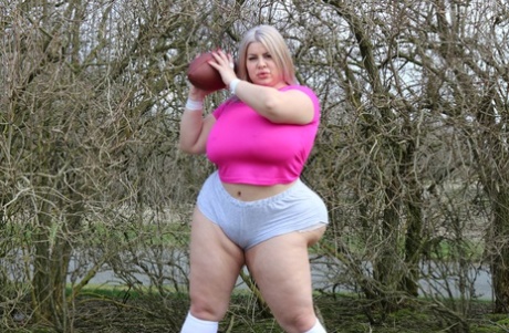 Curvaceous football player Natasha Crown flaunts her huge ass outdoors