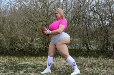 Curvaceous football player Natasha Crown flaunts her huge ass outdoors