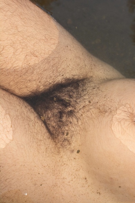 Brunette Harley Hex strips her swimsuit and washes her hairy body in the river