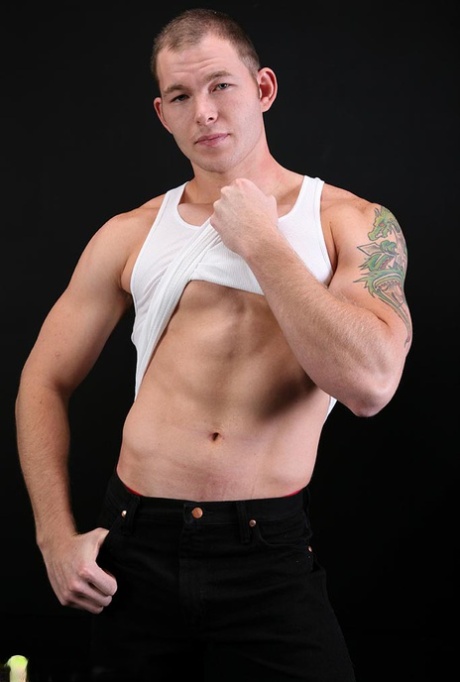 Sexy short haired gay Tex shows his stiff dick and poses naked on a couch
