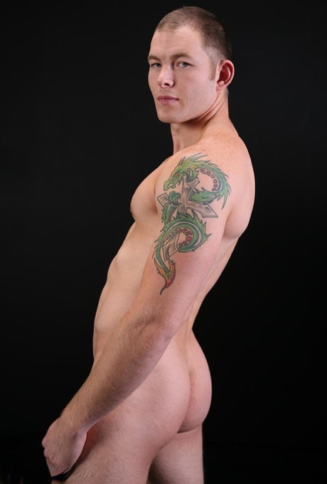 Sexy short haired gay Tex shows his stiff dick and poses naked on a couch