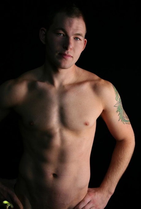 Sexy short haired gay Tex shows his stiff dick and poses naked on a couch