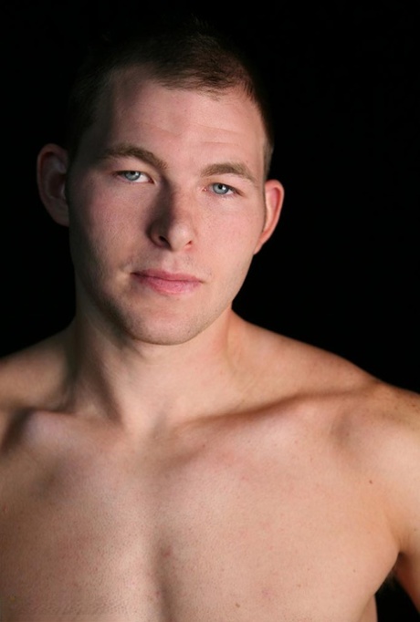 Sexy short haired gay Tex shows his stiff dick and poses naked on a couch