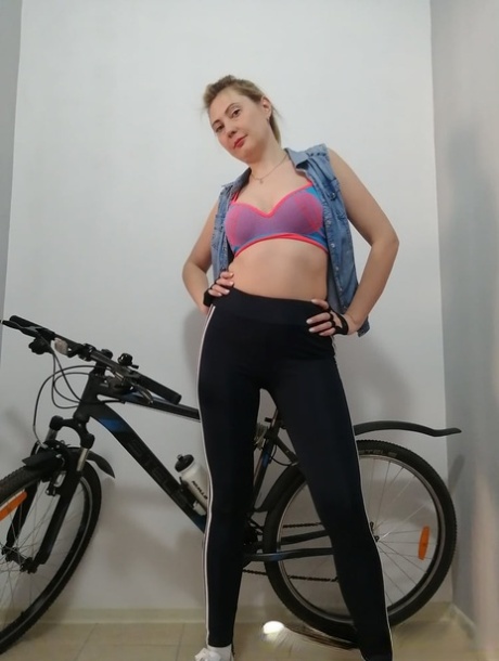 Curvy amateur cyclist undressing and posing naked on her bicycle