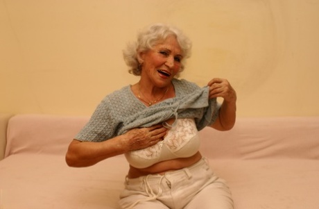 Blonde granny Maria masturbating her horny hairy twat with a glass dildo