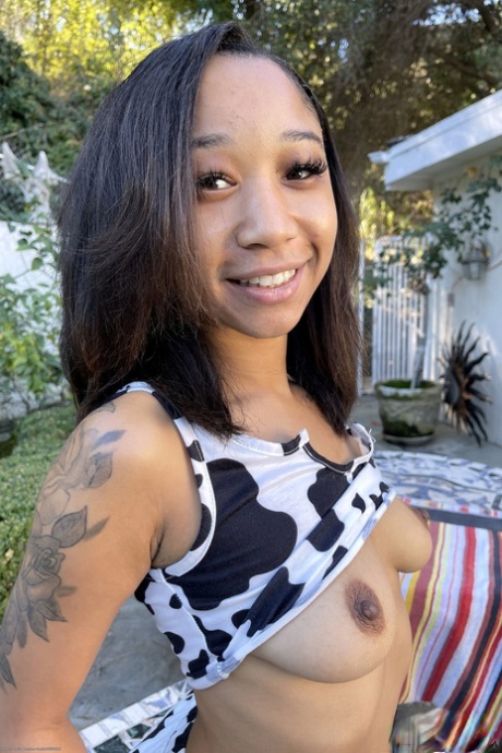 Ebony cutie Alicia Reign shows her shaved pussy with a tampon in it up close
