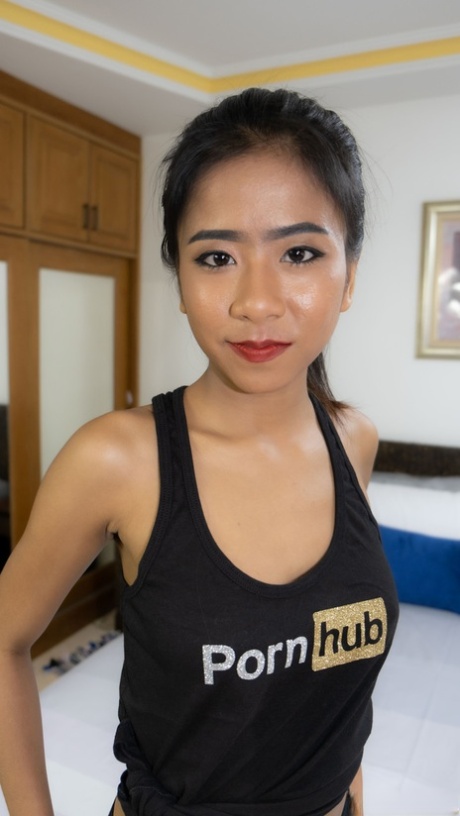 Thai beauty Som poses in her PornHub outfit & shows her big tits & ass