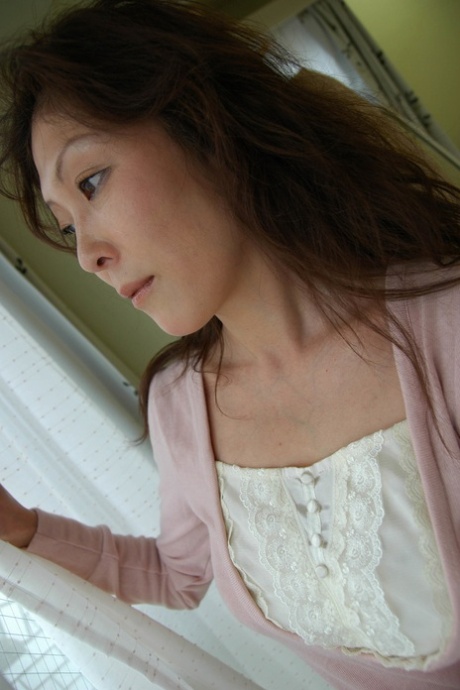 Brunette Asian granny Masako Suzuki reveals her big juggs and nice ass