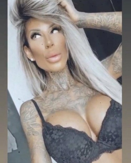 Breathtaking tattooed model Jacky posing in her black lingerie in a solo