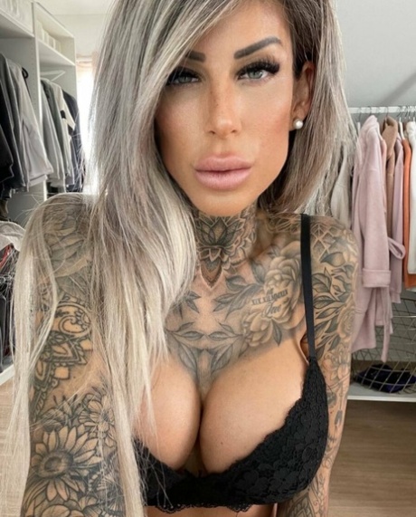 Breathtaking tattooed model Jacky posing in her black lingerie in a solo