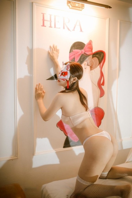 Petite babe shows off her sexy ass wearing white lingerie and stockings