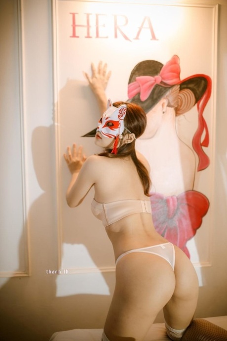 Petite babe shows off her sexy ass wearing white lingerie and stockings