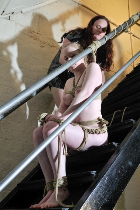 Submissive blonde lesbian Satine Spark gets tied up in rope bondage