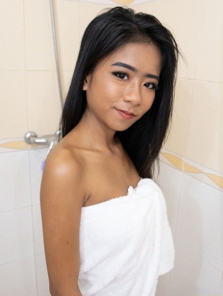 Hot Asian babe Som shows her lovely tits & her shaved pussy in the bathroom