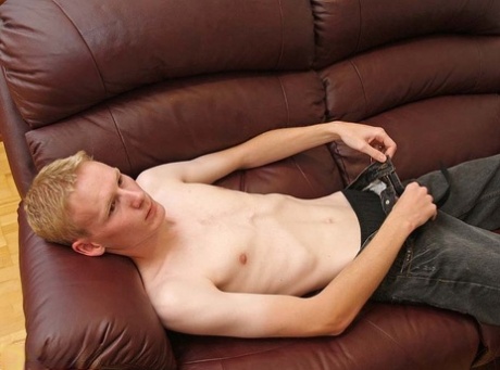Hot twink strips & jerks his small dick until he ejaculates on the couch